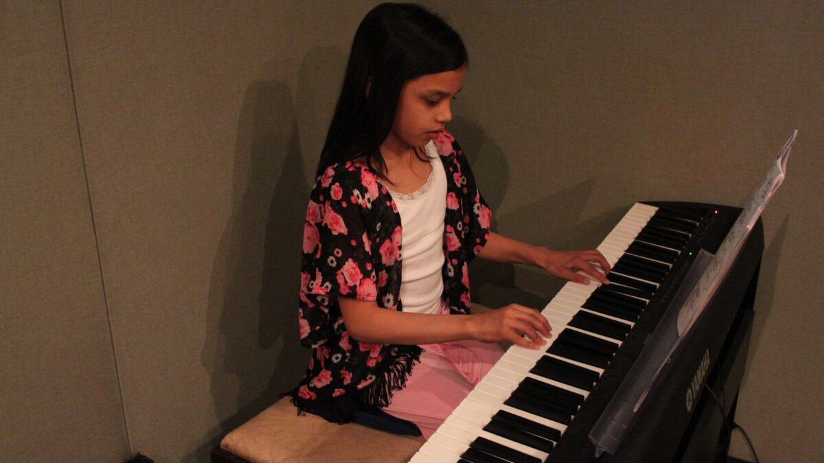 IMG_8445_wp A youth playing a piano keyboard in a radio studio