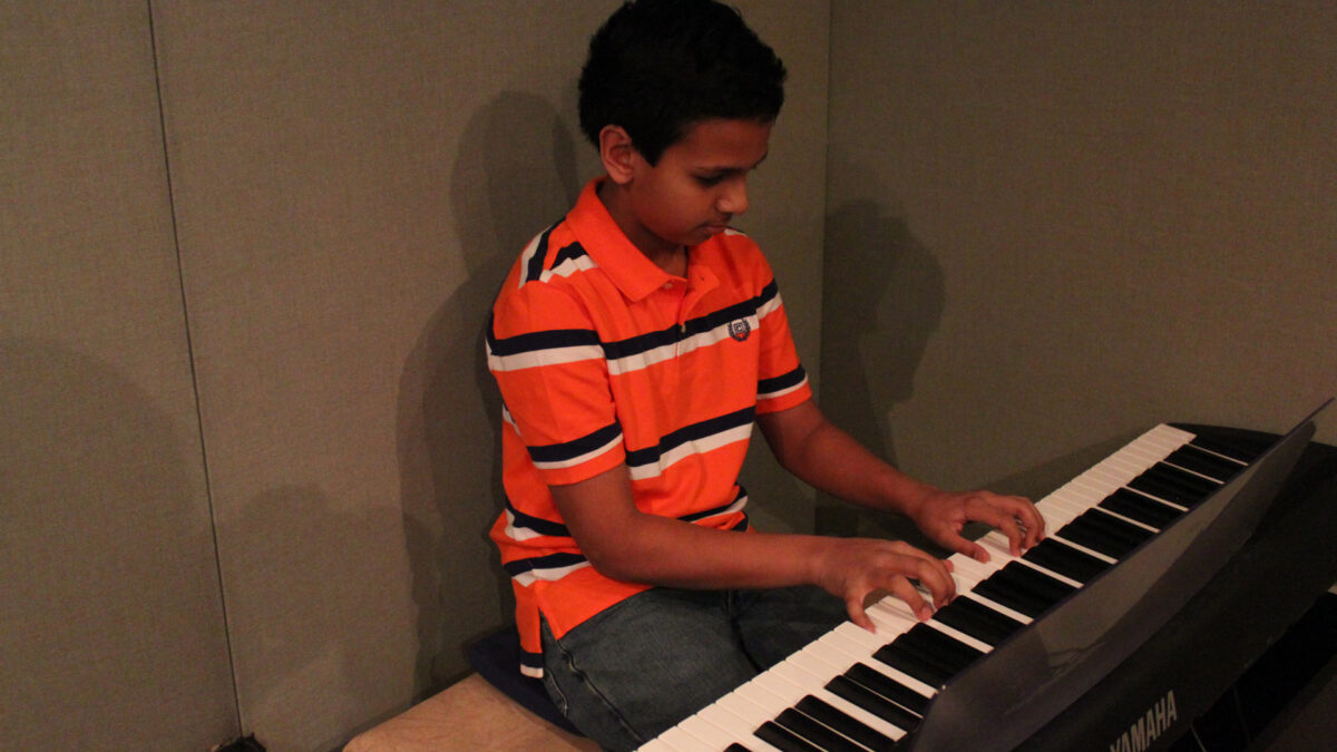 IMG_8446_wp A youth playing a piano keyboard in a radio studio