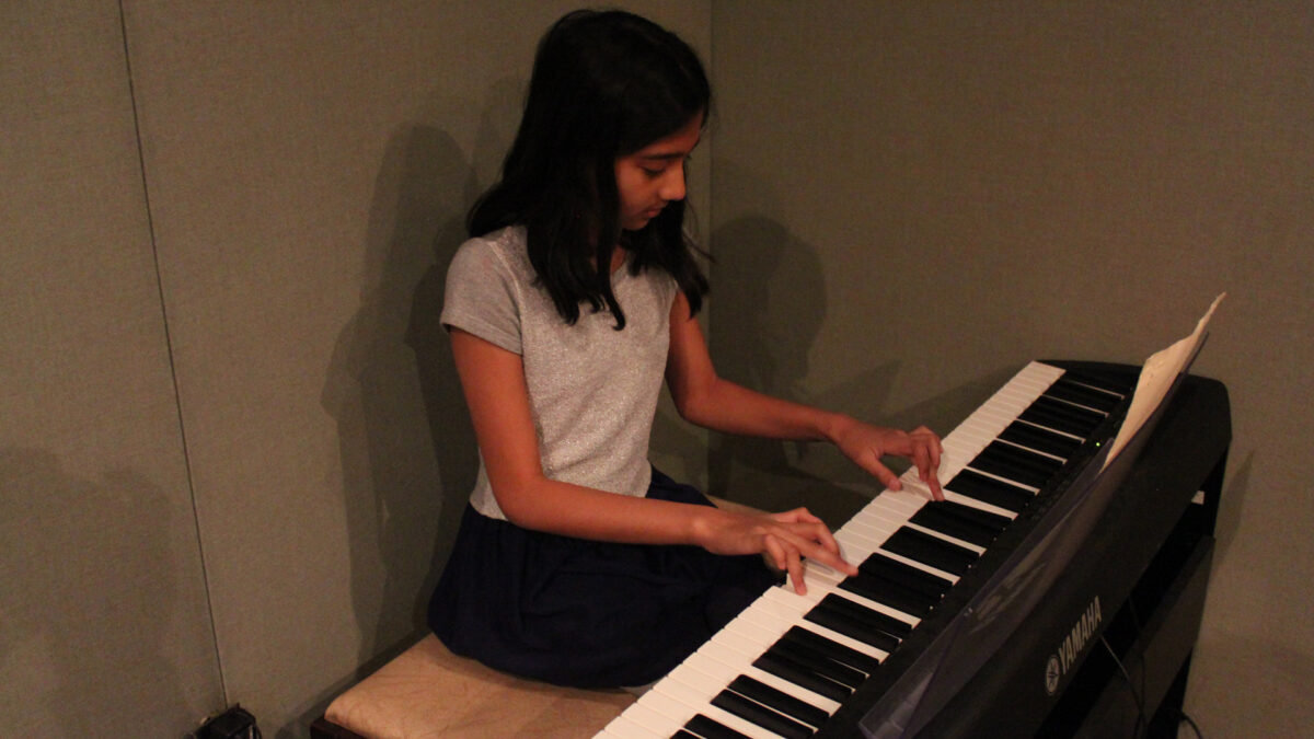 IMG_8448_wp A youth playing a piano keyboard in a radio studio