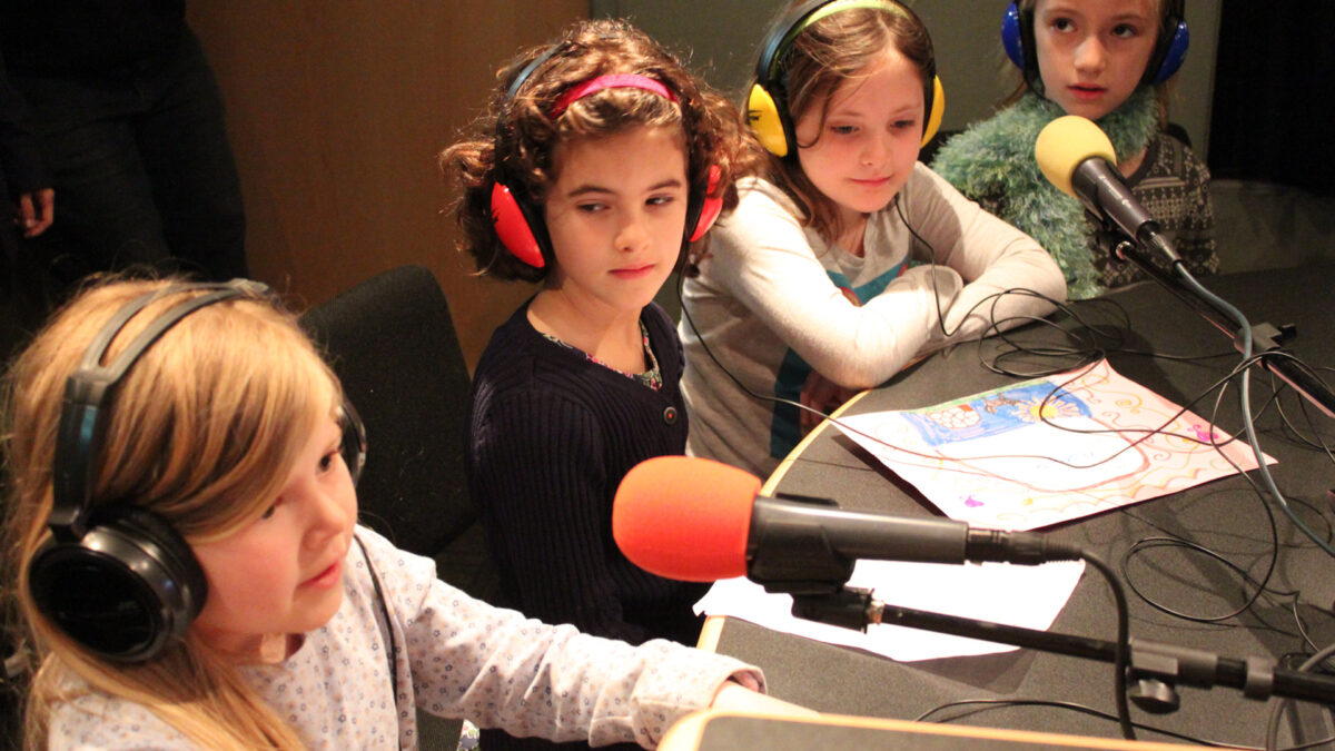 IMG_8460_wp Four youth speaking into microphones in a radio studio