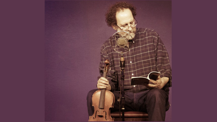 An adult looking down at a book while sitting behind a microphone and holding a violin in front of a purple background
