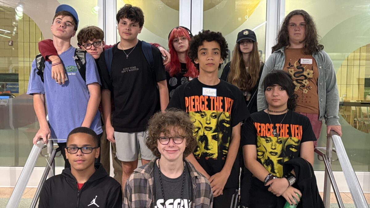 ten teens standing together on stairs for a group photo