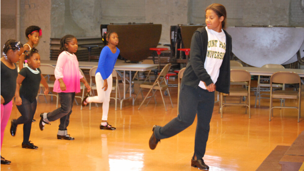 An adult leading five youth in a dance class