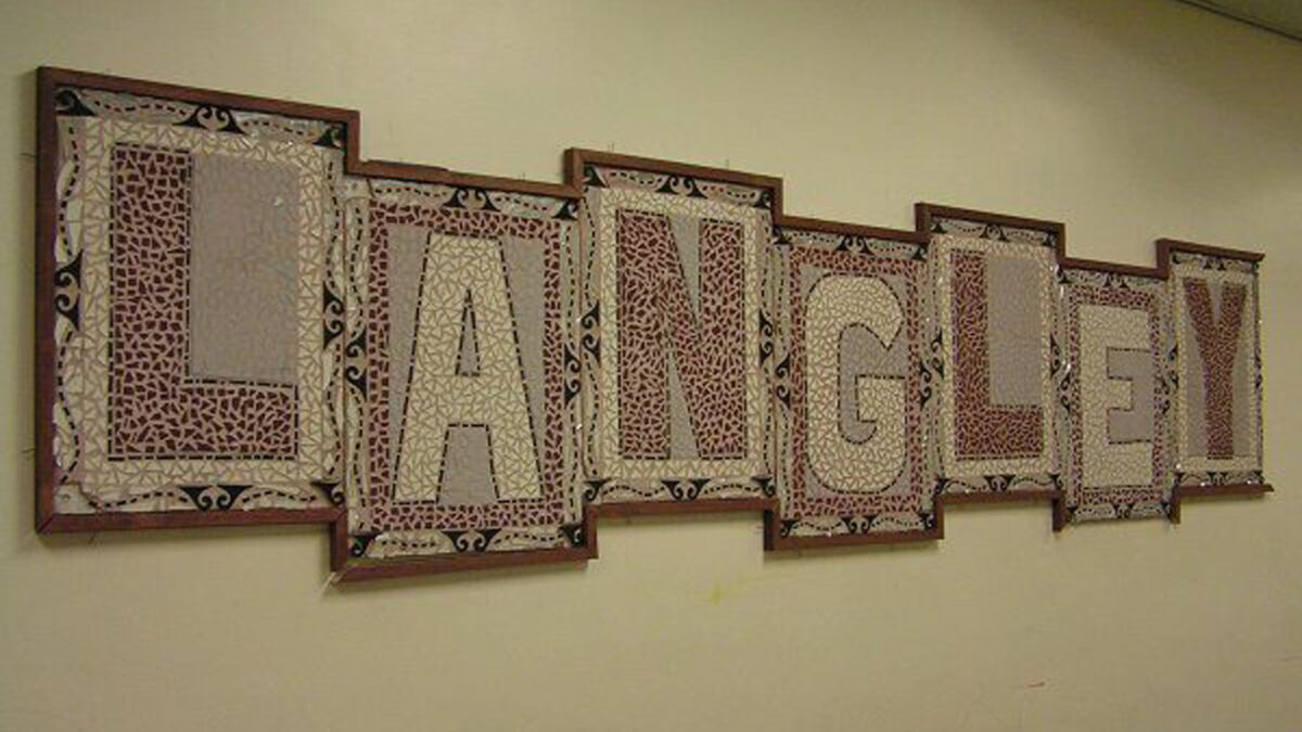 A framed mosaic spelling out the word "Langley" in a hallway