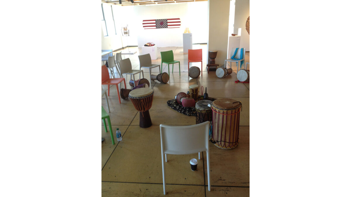 photo-1-(7)_wp Multiple percussion instruments sitting underneath and inside a circle of multicolored chairs