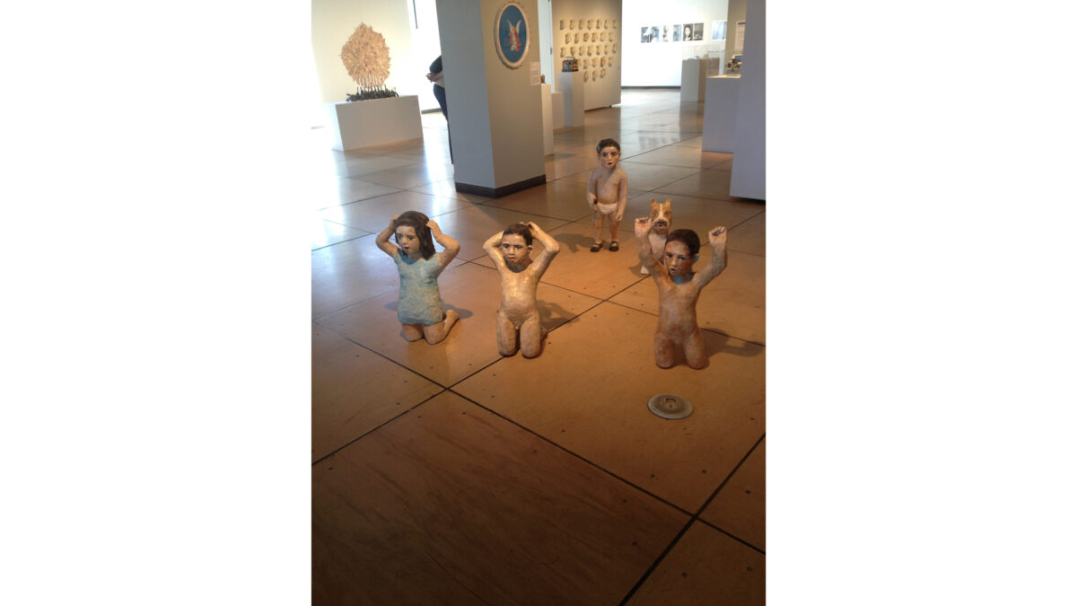 photo-2-(9)_wp Four statues of children and a statue of a dog in an art museum