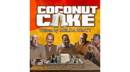 Five adults sitting around a chessboard with coconut cake on top in front of a red and yellow background