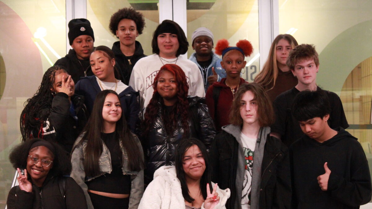 IMG_4163 Fifteen teens smiling and posing on a staircase