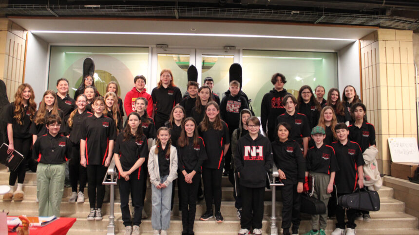 Thirty five youth smiling and standing on a staircase
