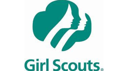 A green logo in the shape of a clover, along with the text "Girl scouts" in light green