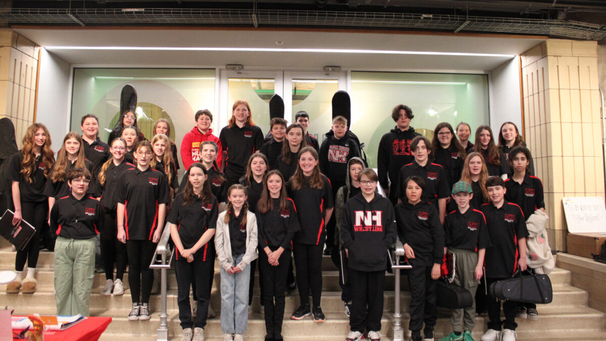 Thirty-five teens smiling and standing on a staircase