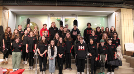 Thirty-five teens smiling and standing on a staircase