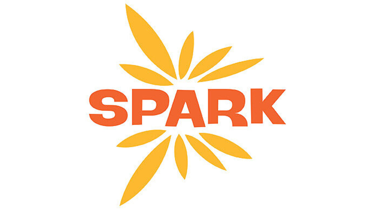 A graphic of yellow feathers around the text "Spark" in red font