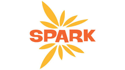 A graphic of yellow feathers around the text "Spark" in red font