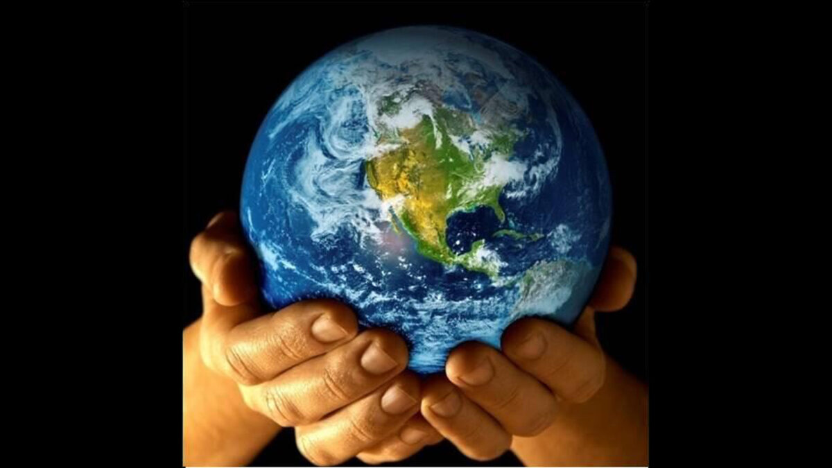 Two hands holding the planet Earth.