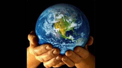 Two hands holding the planet Earth.