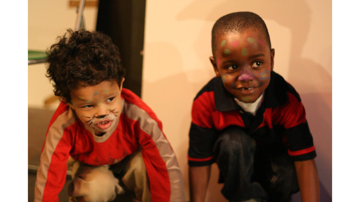 spark-animals-twokidssmall_wp Two youth wearing face paint smiling while crouching down