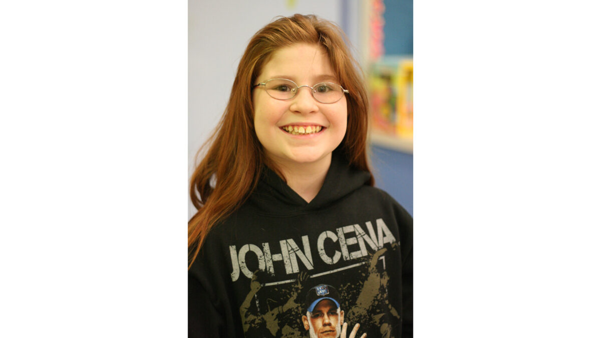 A youth smiling at the camera