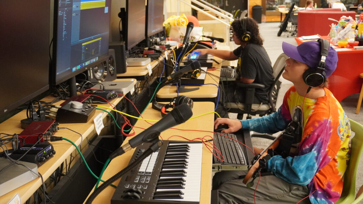 Rhyme and Reason-9 two teens work at two computers on separate projects