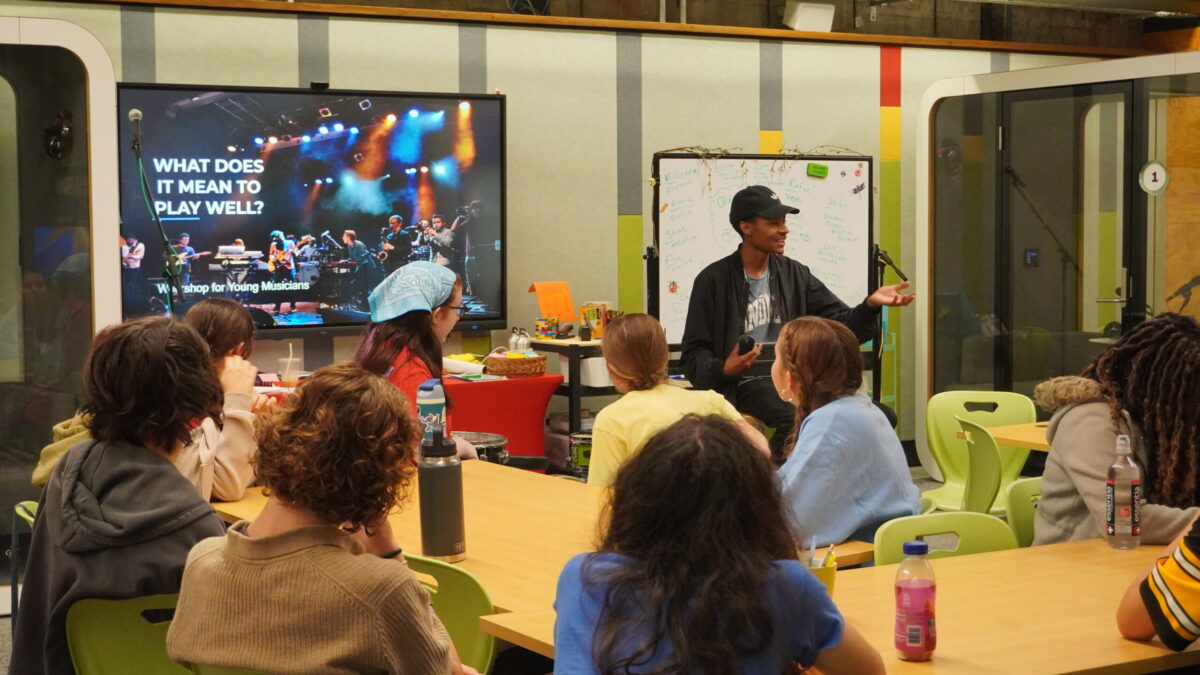 Rhyme and Reason-11 an adult speaks to a group of teens in a classroom