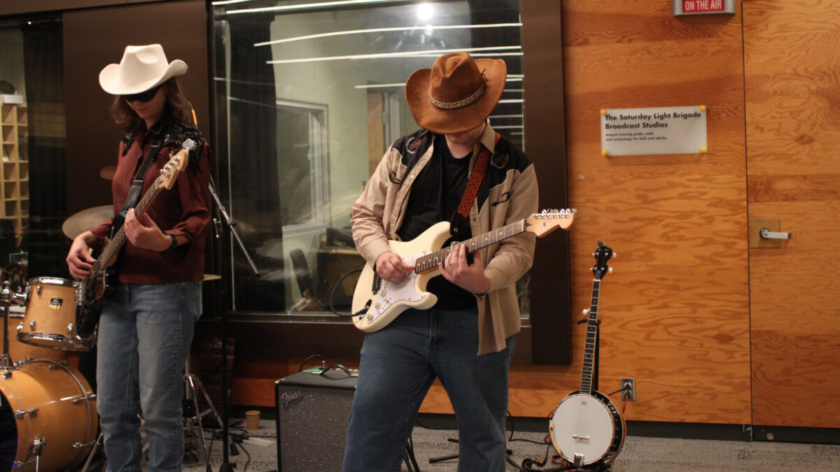 Gallop-Gallop-Gallop_4 An adult playing electric bass and an adult playing electric guitar