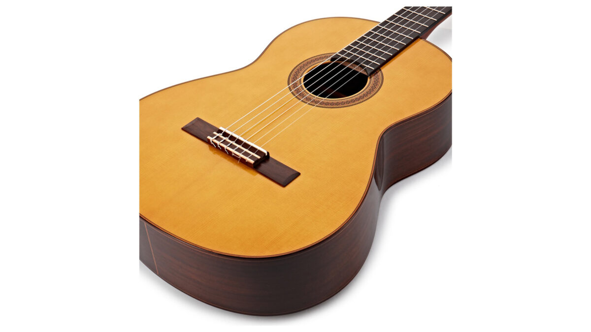 An acoustic guitar on a white background