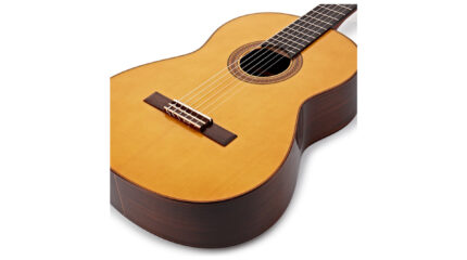 An acoustic guitar on a white background