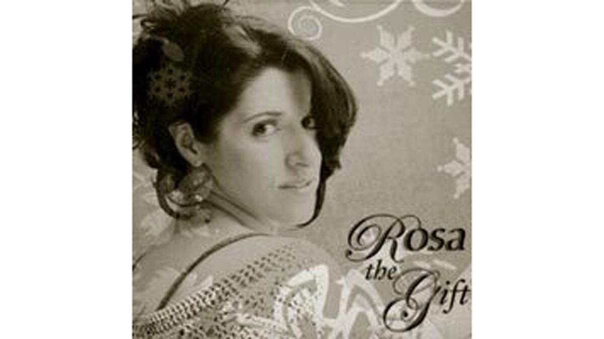 A sepia tone image of an adult looking over their right shoulder while surrounded by snowflakes