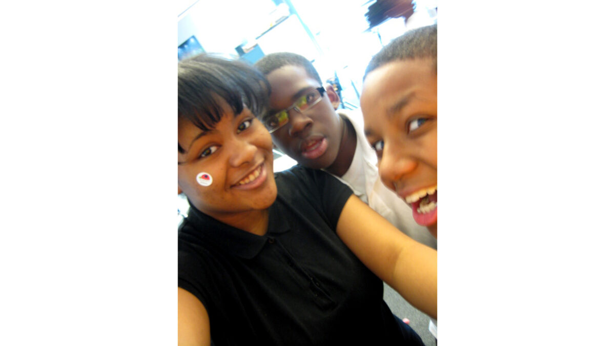 Three youth smiling at the camera