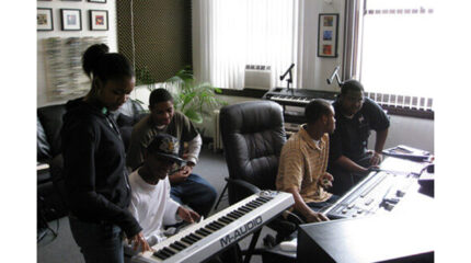 Three teens looking at a piano keyboard and two teens looking at an audio mixer