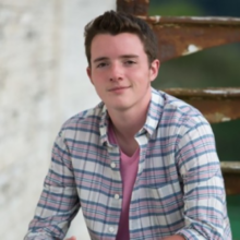 Person with brown hair and collared shirt